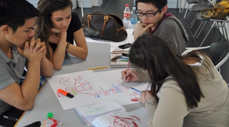International students collaborating on a group project at Domus Academy, Italy