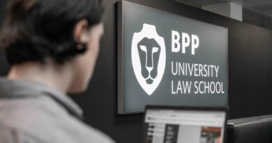 Student at BPP University Law School with scholarship application on laptop screen in front of university logo