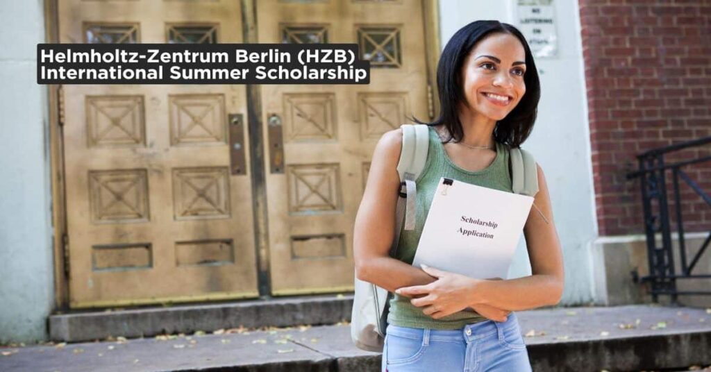 A smiling student holding a scholarship application form outside a university building – Helmholtz-Zentrum Berlin International Scholarship 2025.