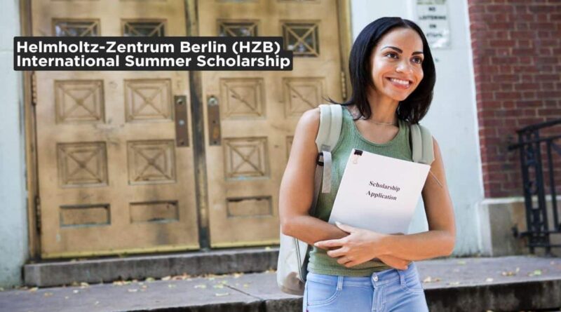 A smiling student holding a scholarship application form outside a university building – Helmholtz-Zentrum Berlin International Scholarship 2025.